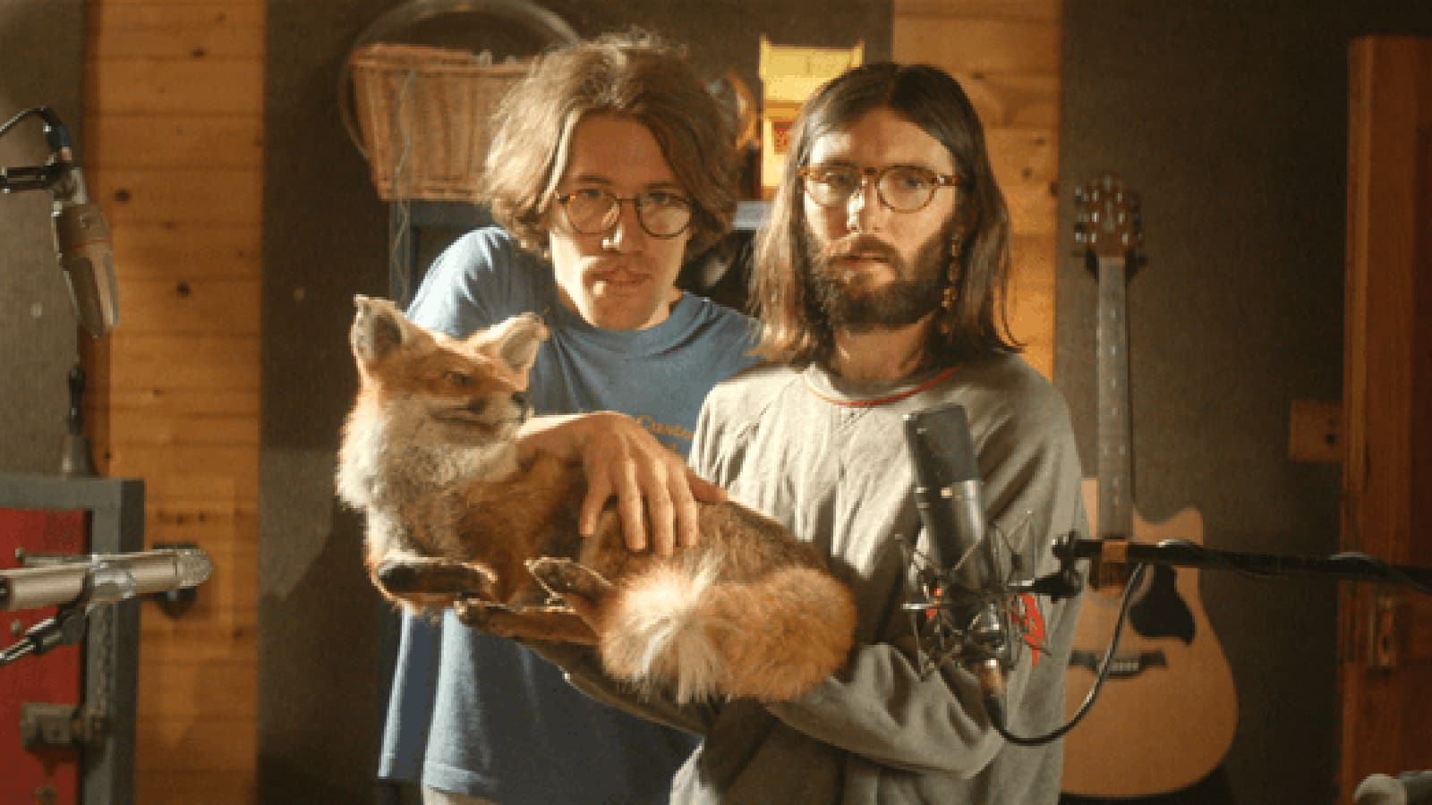 Art of Foley two cast members holding a stuffed fox in a sound studio
